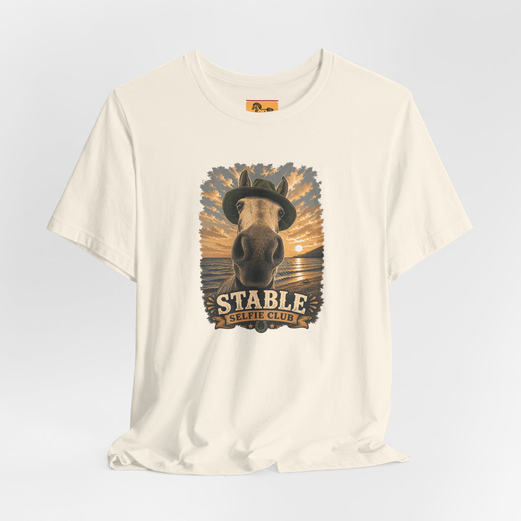 Stable Selfie Club unisex t-shirt  featuring original equestrian artwork of a horse wearing a hat taking a selfie at sunset on a beach, printed on Bella & Canvas 3001 tee by Hay there Horse Art.