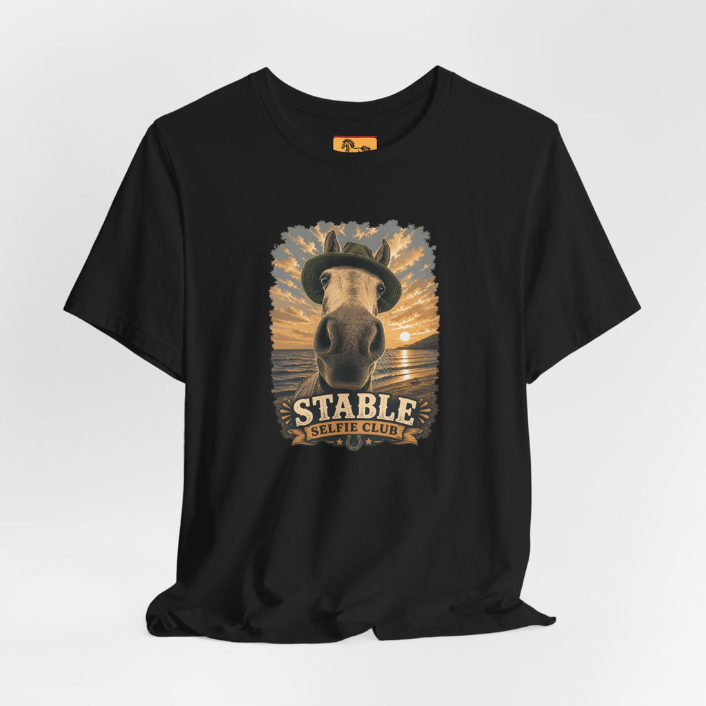 Stable Selfie Club unisex t-shirt in black, featuring original equestrian artwork of a horse wearing a hat taking a selfie at sunset on a beach, printed on Bella & Canvas 3001 tee by Hay there Horse Art.