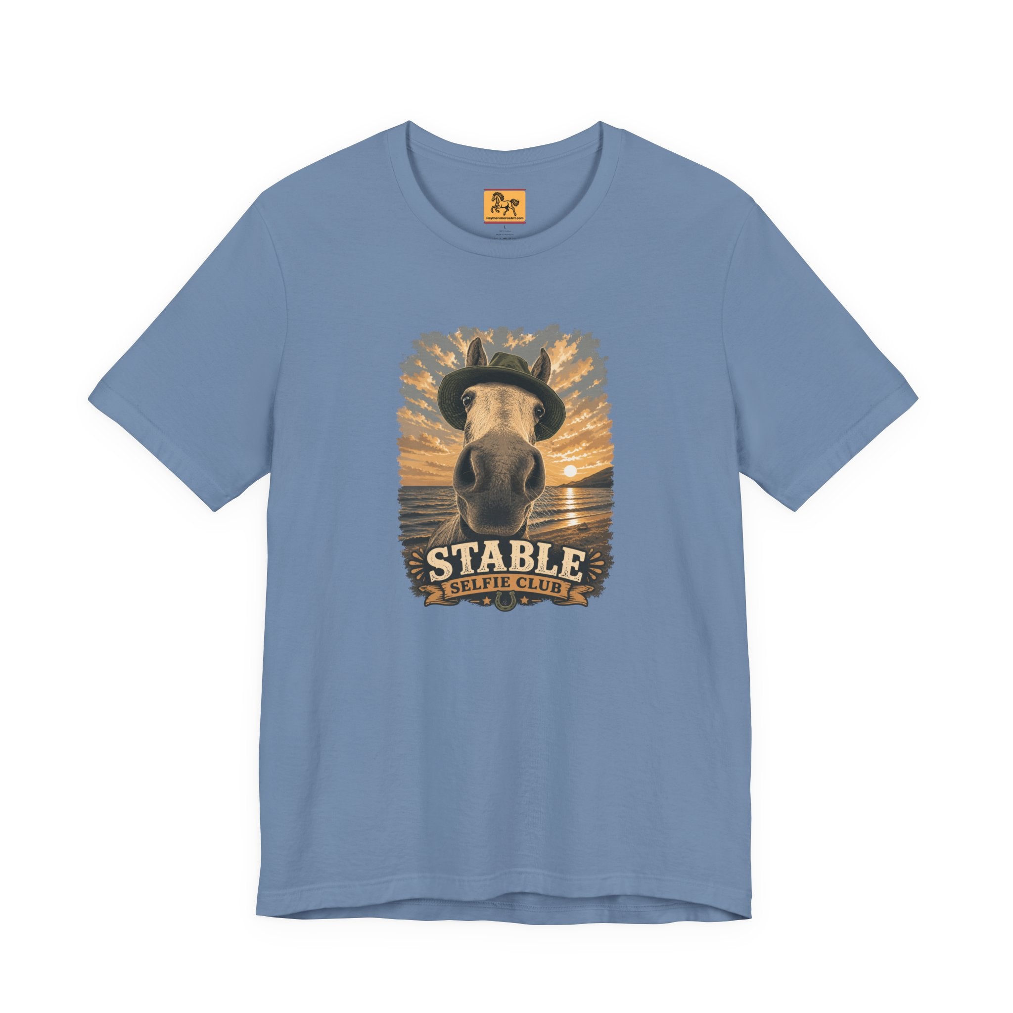 Stable Selfie Club unisex t-shirt in steel blue, featuring original equestrian artwork of a horse wearing a hat taking a selfie at sunset on a beach, printed on Bella & Canvas 3001 tee by Hay there Horse Art.