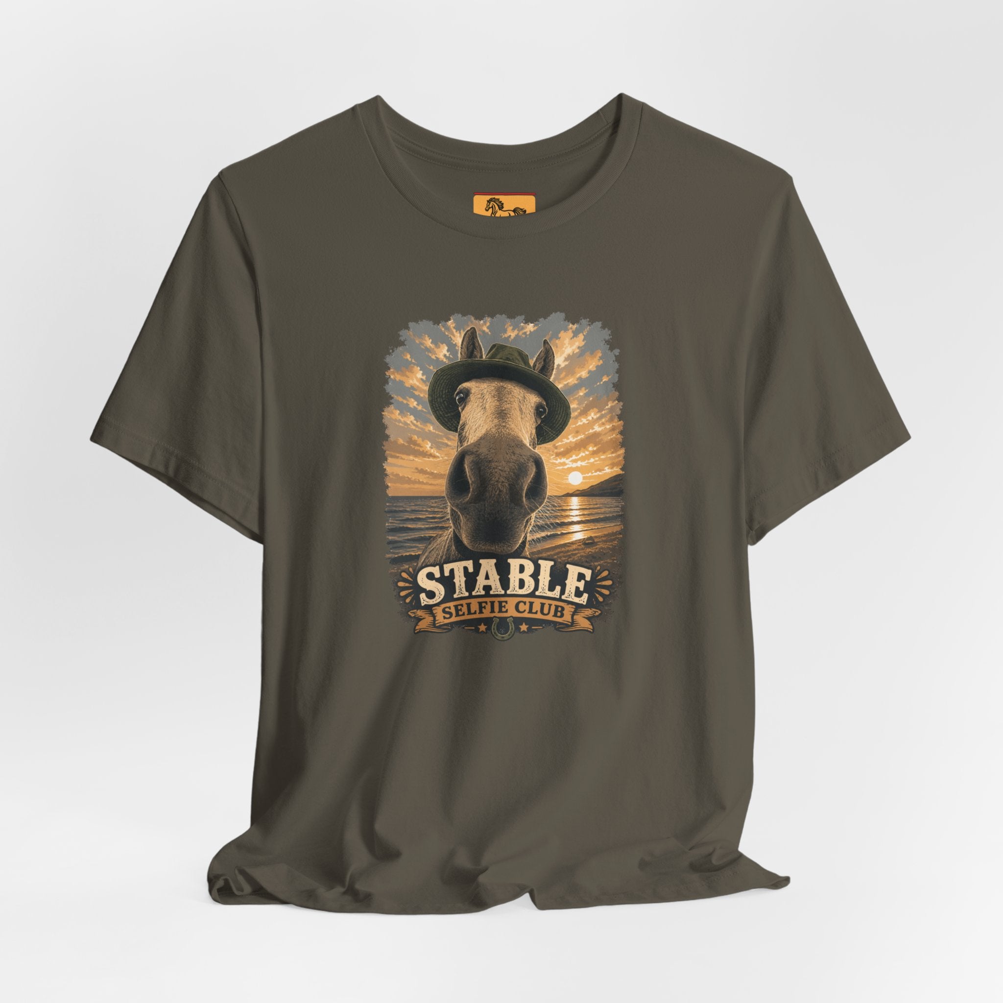Stable Selfie Club unisex t-shirt in army, featuring original equestrian artwork of a horse wearing a hat taking a selfie at sunset on a beach, printed on Bella & Canvas 3001 tee by Hay there Horse Art.