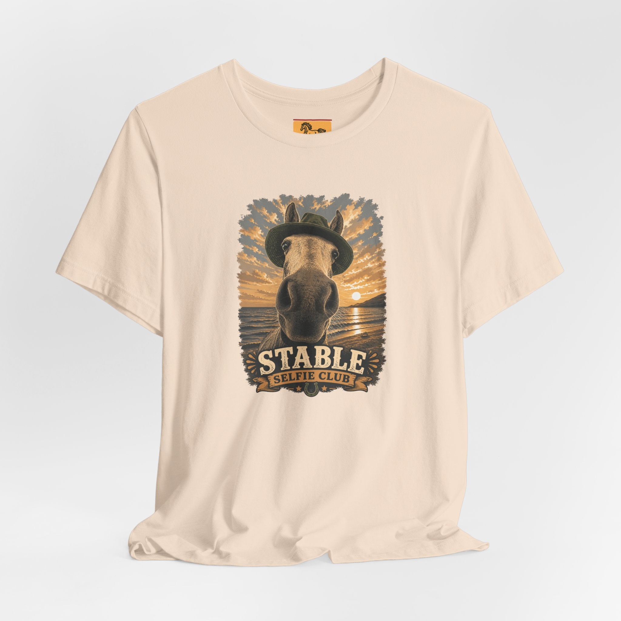 Stable Selfie Club unisex t-shirt  featuring original equestrian artwork of a horse wearing a hat taking a selfie at sunset on a beach, printed on Bella & Canvas 3001 tee by Hay there Horse Art.