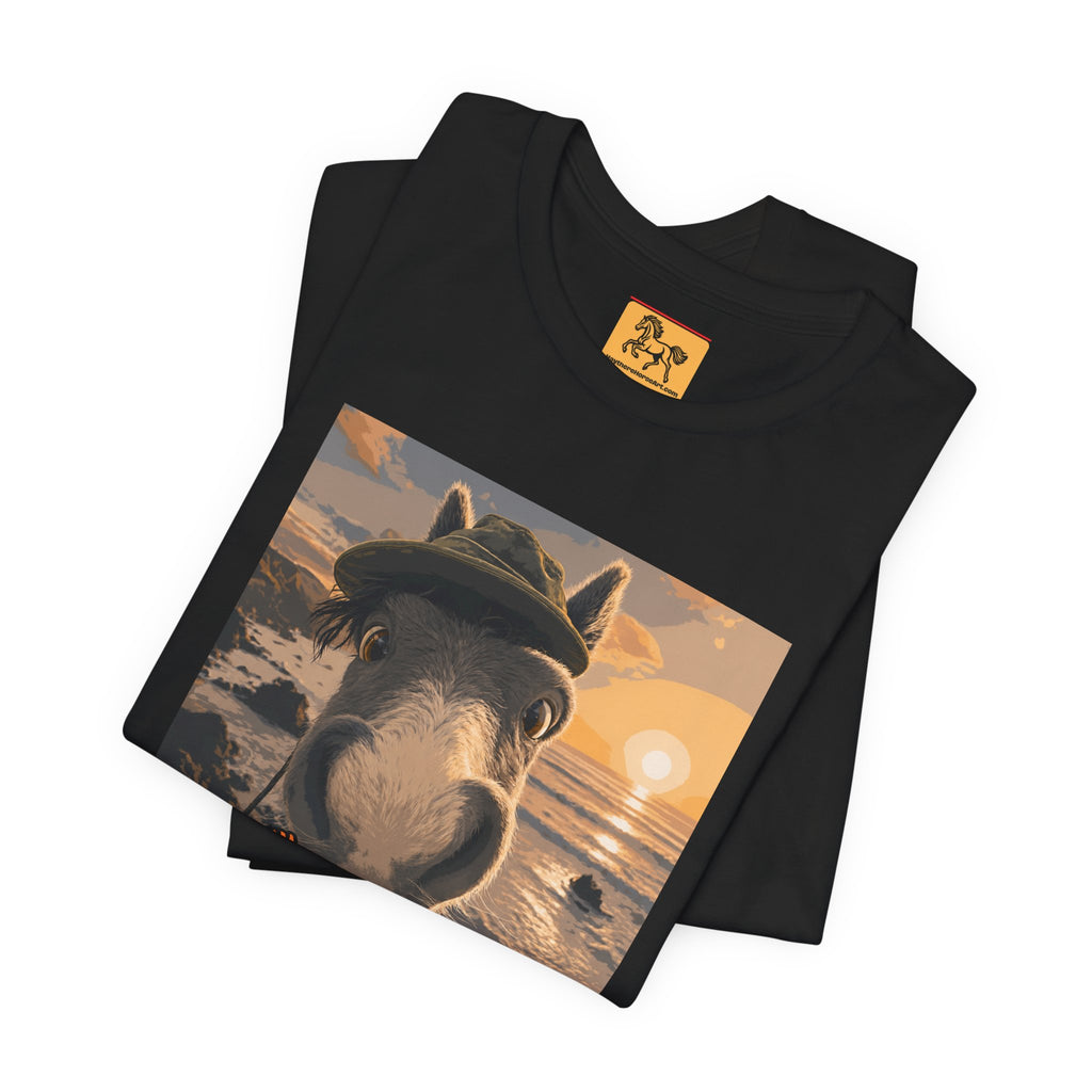 A Bella + Canvas 3001 unisex t-shirt featuring an illustrated horse taking a beach selfie at sunset, wearing a hat, with the words 'Loving my holiday XXX' in orange script. 