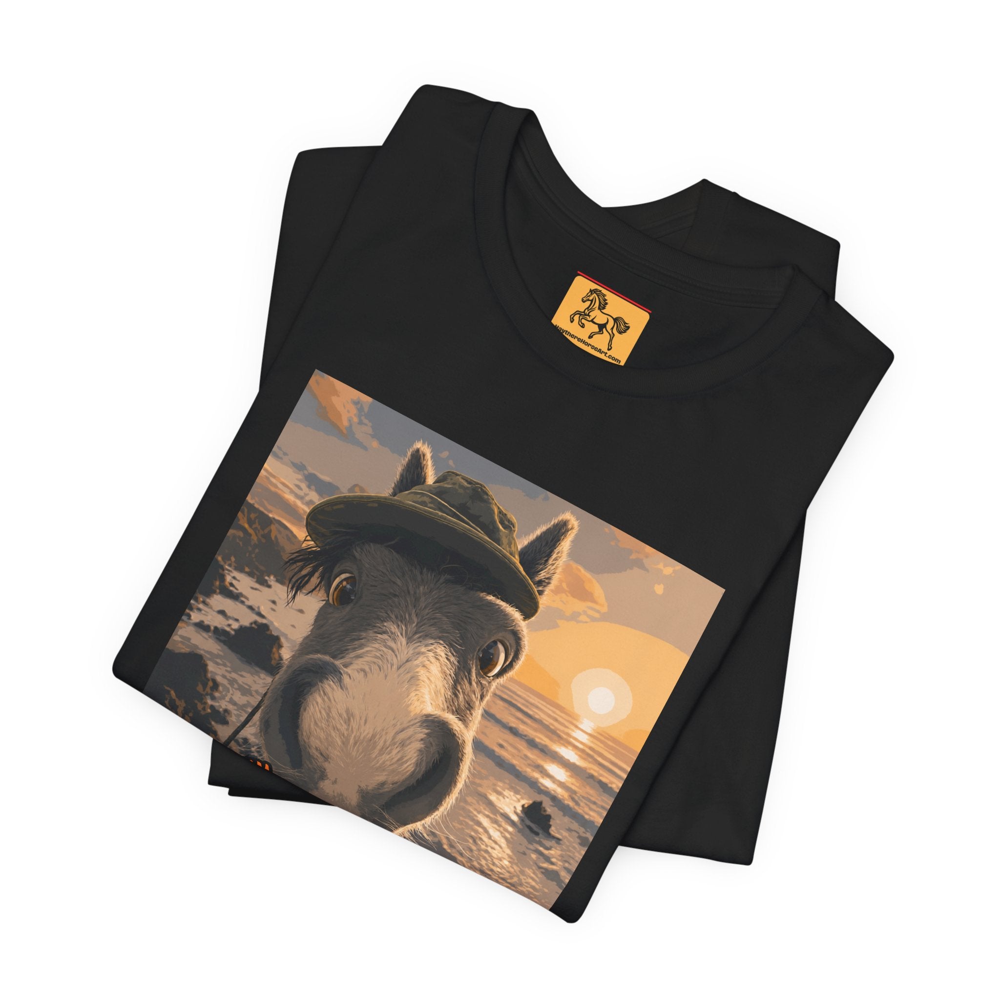 A Bella + Canvas 3001 unisex t-shirt featuring an illustrated horse taking a beach selfie at sunset, wearing a hat, with the words 'Loving my holiday XXX' in orange script. 