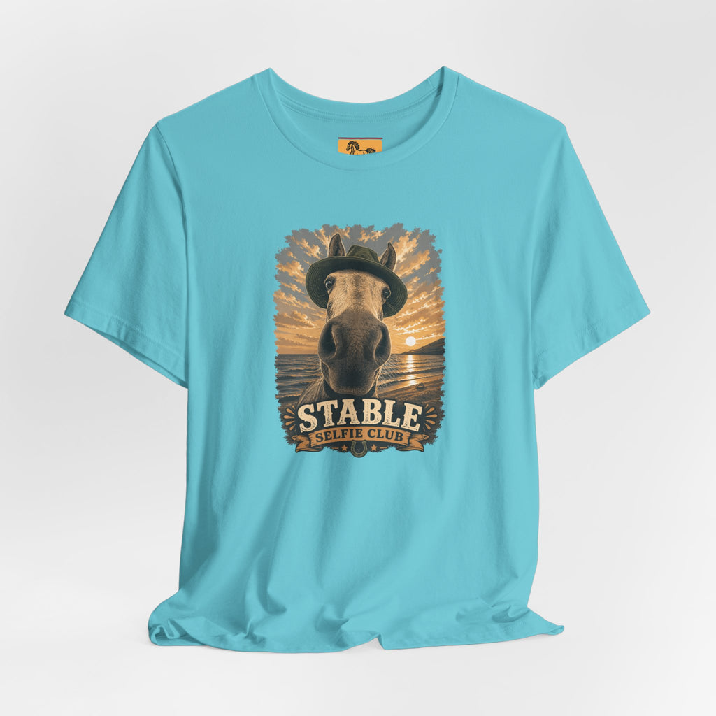 Stable Selfie Club unisex t-shirt  featuring original equestrian artwork of a horse wearing a hat taking a selfie at sunset on a beach, printed on Bella & Canvas 3001 tee by Hay there Horse Art.