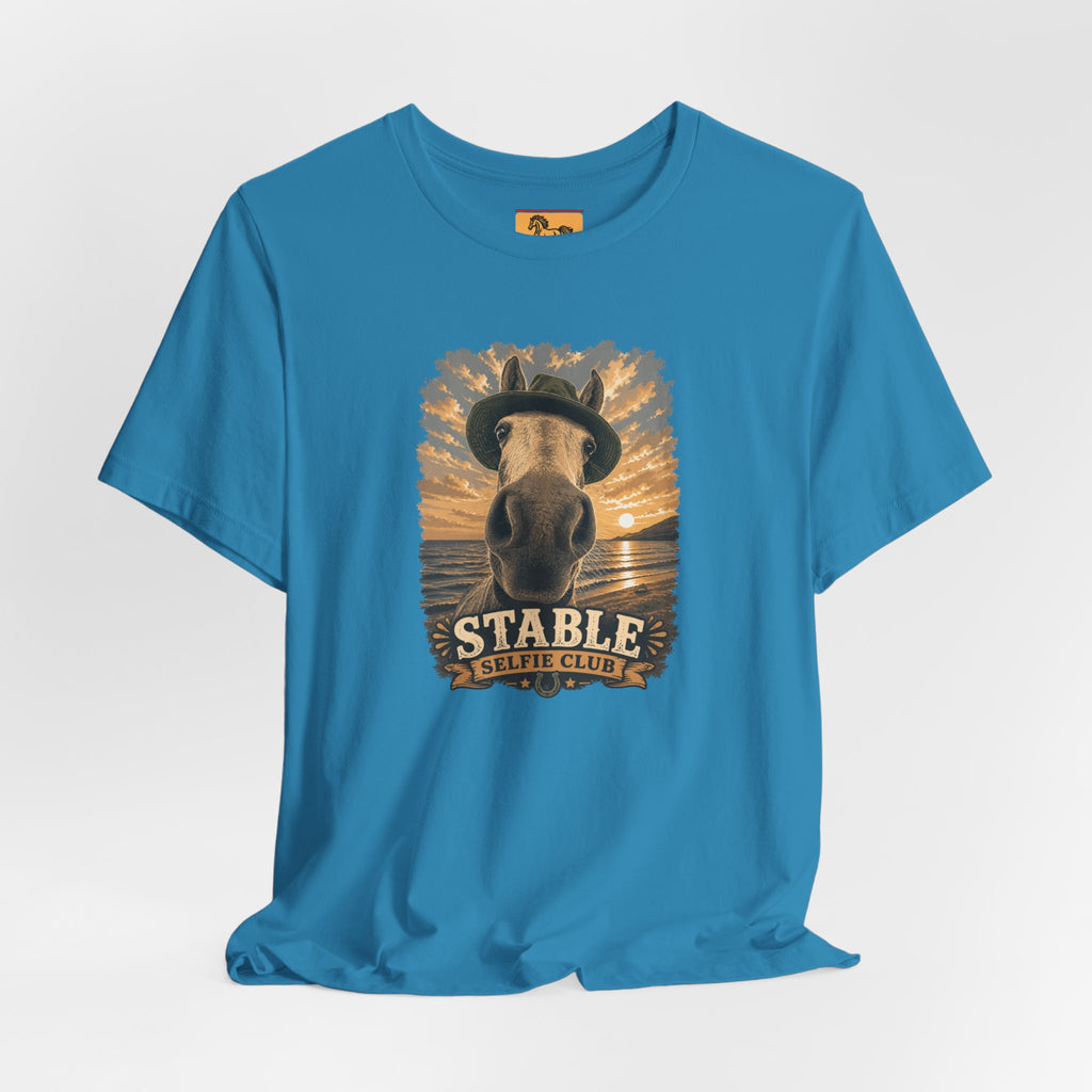 Stable Selfie Club unisex t-shirt  featuring original equestrian artwork of a horse wearing a hat taking a selfie at sunset on a beach, printed on Bella & Canvas 3001 tee by Hay there Horse Art.