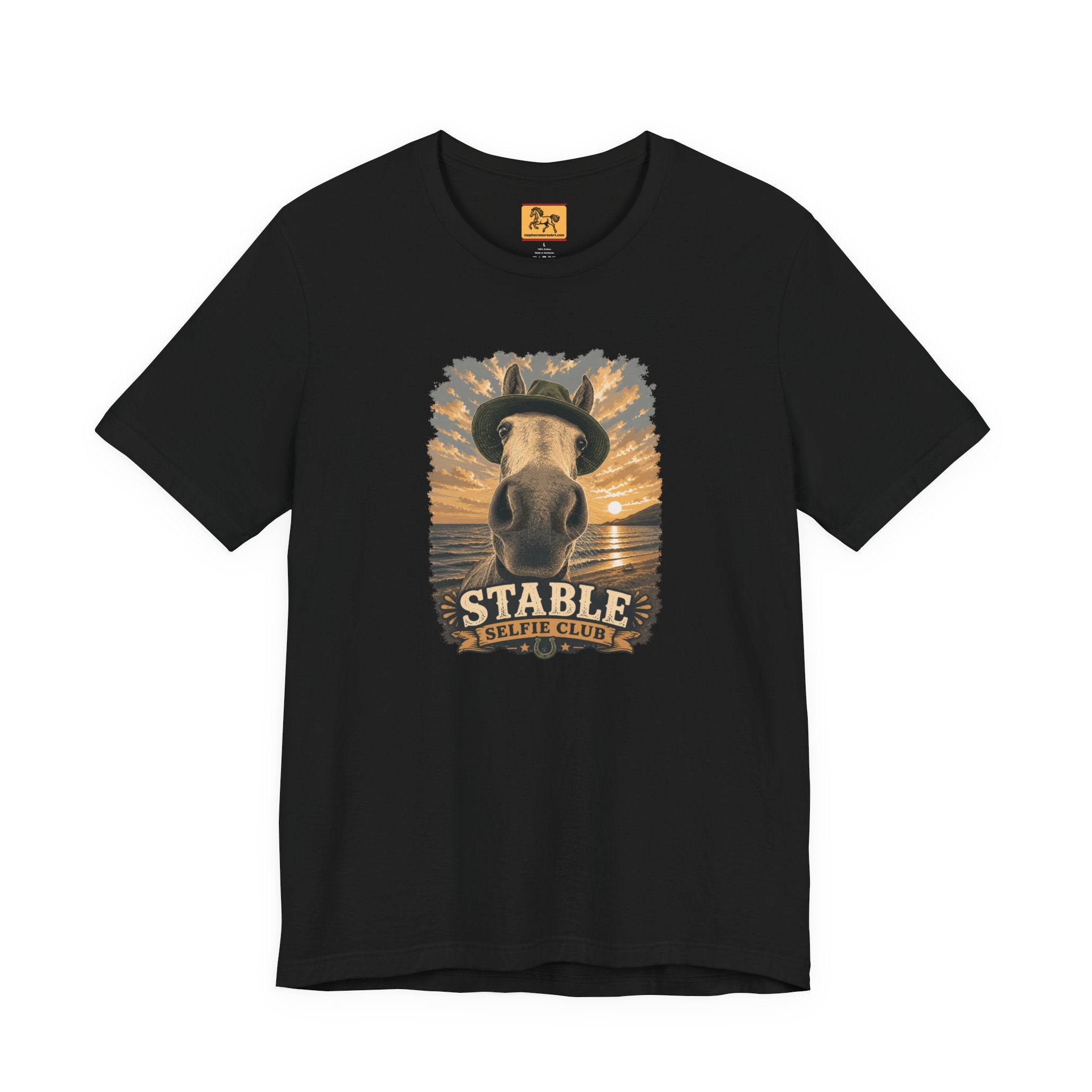 Stable Selfie Club unisex t-shirt in black, featuring original equestrian artwork of a horse wearing a hat taking a selfie at sunset on a beach, printed on Bella & Canvas 3001 tee by Hay here Horse Art.