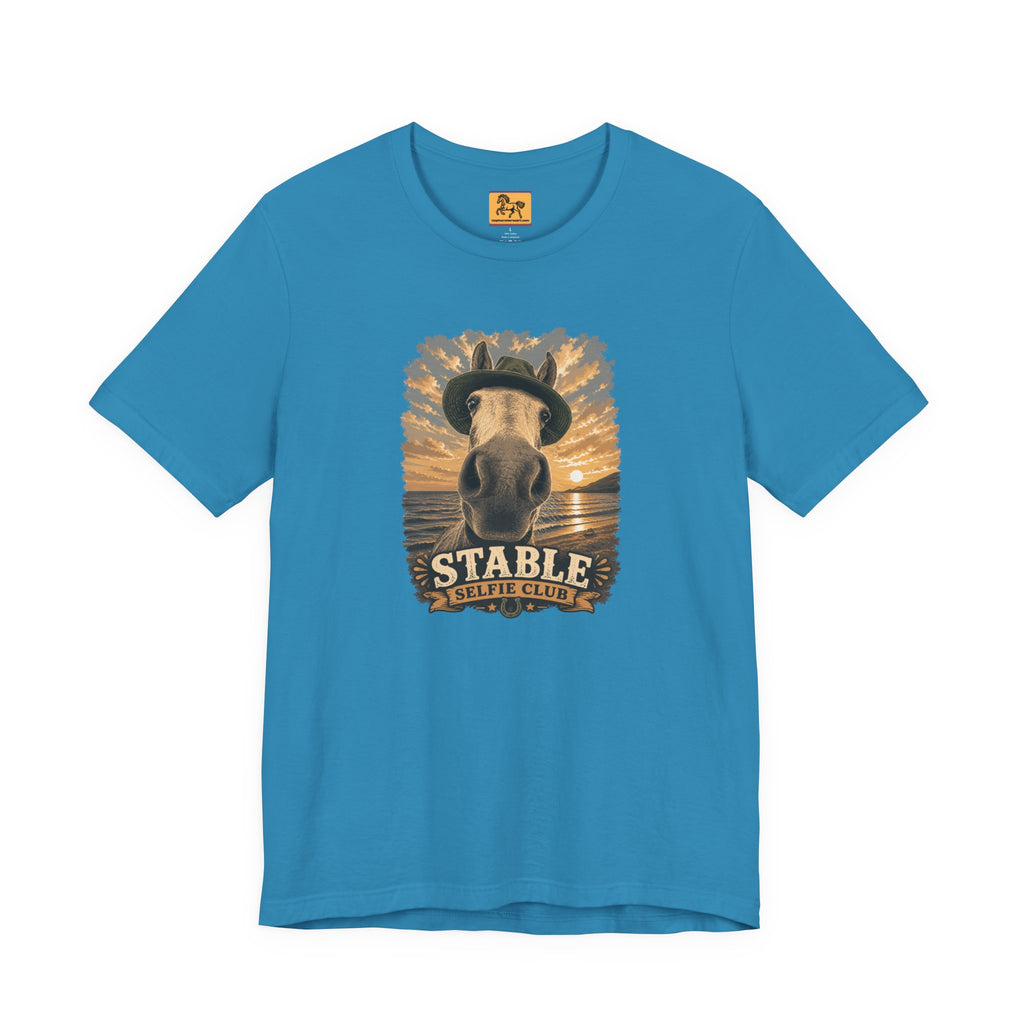 Stable Selfie Club unisex t-shirt in aqua, featuring original equestrian artwork of a horse wearing a hat taking a selfie at sunset on a beach, printed on Bella & Canvas 3001 tee by Hay there Horse Art.
