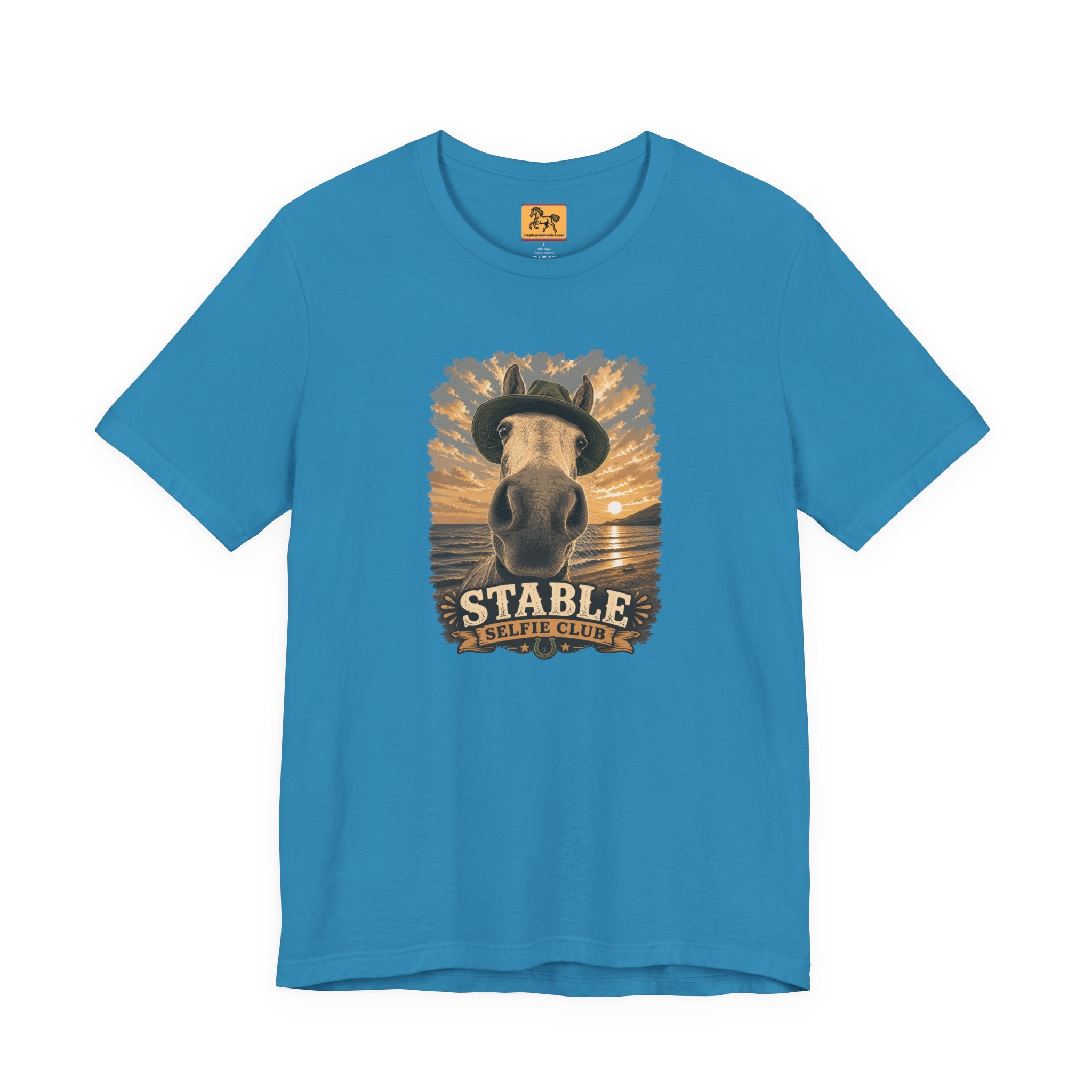 Stable Selfie Club unisex t-shirt in aqua, featuring original equestrian artwork of a horse wearing a hat taking a selfie at sunset on a beach, printed on Bella & Canvas 3001 tee by Hay there Horse Art.