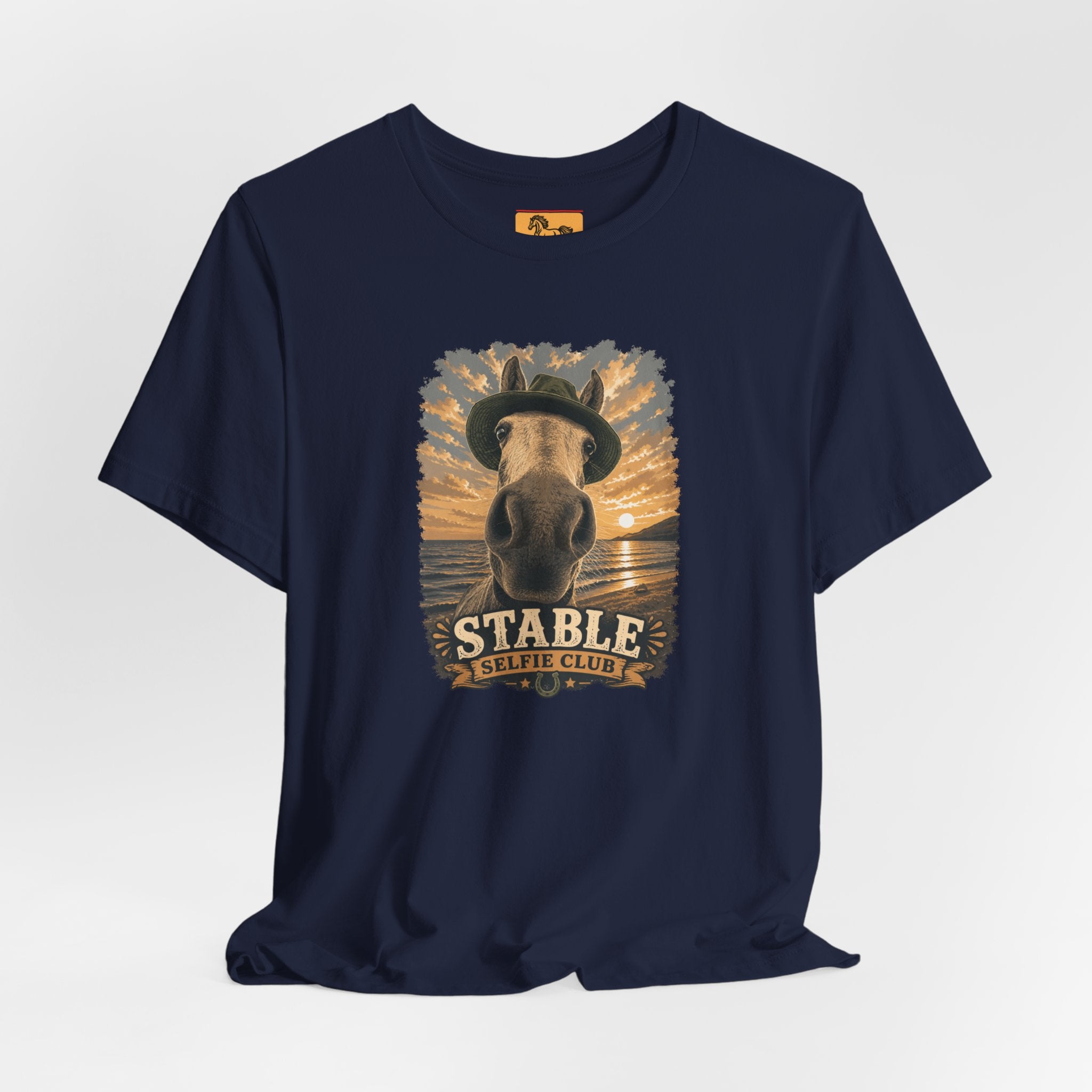 Stable Selfie Club unisex t-shirt  featuring original equestrian artwork of a horse wearing a hat taking a selfie at sunset on a beach, printed on Bella & Canvas 3001 tee by Hay there Horse Art.