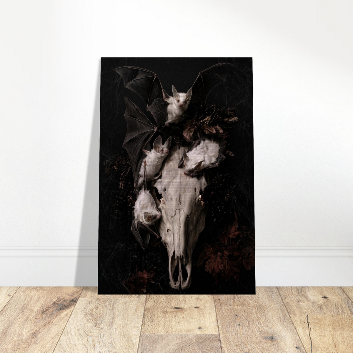 Gothic vanitas metal wall art print of three albino bats and a weathered horse skull with glowing eye sockets, surrounded by dried botanicals and cobwebs on a black background, Dutch Golden Age still life style, brushed aluminum print