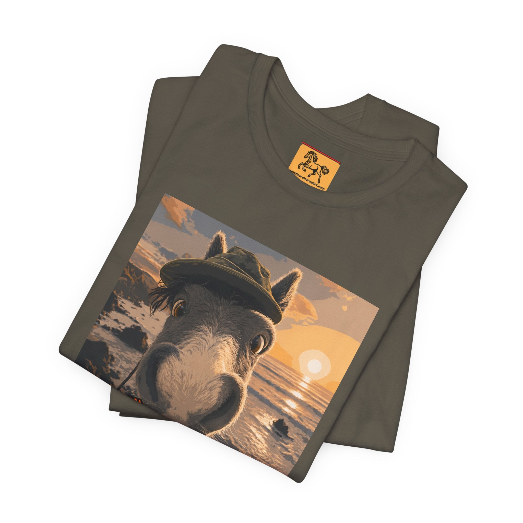 A Bella + Canvas 3001 unisex t-shirt featuring an illustrated horse taking a beach selfie at sunset, wearing a hat, with the words 'Loving my holiday XXX' in orange script. 