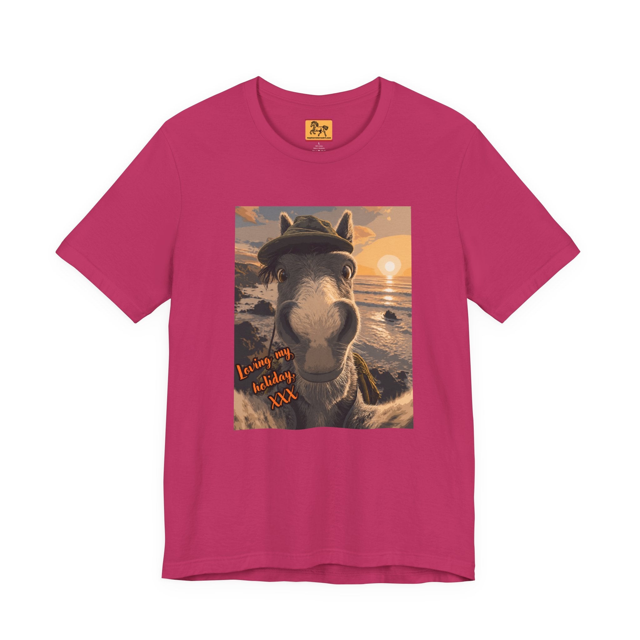 A berry color Bella + Canvas 3001 unisex t-shirt featuring an illustrated horse taking a beach selfie at sunset, wearing a hat, with the words 'Loving my holiday XXX' in orange script. 