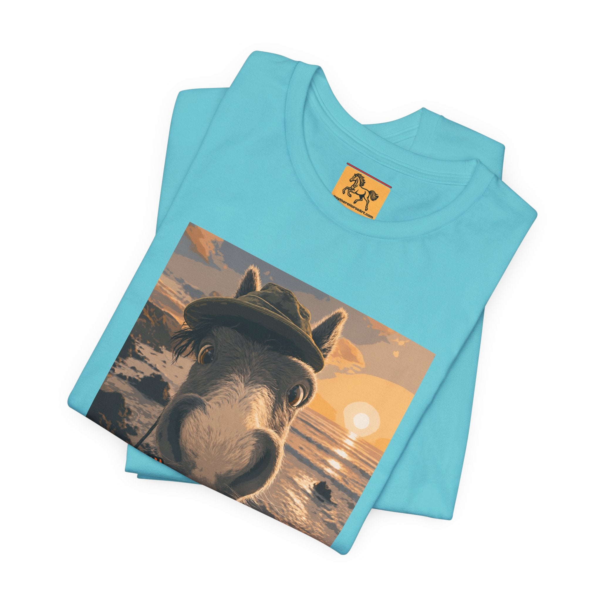 A Bella + Canvas 3001 unisex t-shirt featuring an illustrated horse taking a beach selfie at sunset, wearing a hat, with the words 'Loving my holiday XXX' in orange script. 